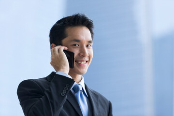 Chinese business man using a smartphone.