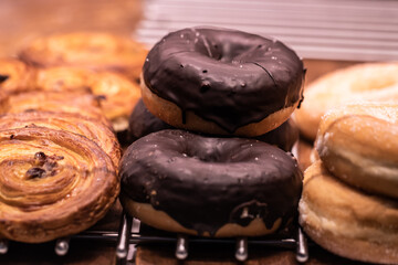 Close-up of chocolate donut with other sweets