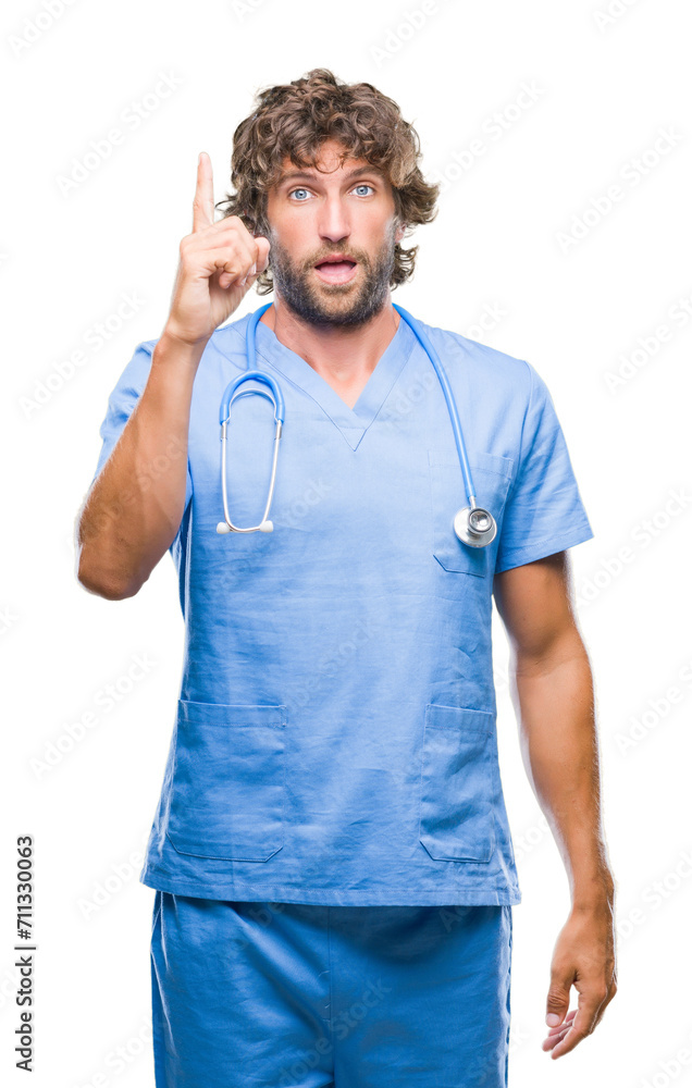 Sticker Handsome hispanic surgeon doctor man over isolated background pointing finger up with successful idea. Exited and happy. Number one.