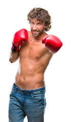 Handsome hispanic boxer man wearing boxing gloves over isolated background with a happy and cool smile on face. Lucky person.