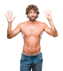 Fototapeta premium Handsome hispanic model man sexy and shirtless over isolated background showing and pointing up with fingers number nine while smiling confident and happy.
