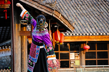 a young girl in a Chinese national dress, wearing a dragon mask, against the background of national...