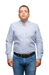 Middle age arab business man over isolated background puffing cheeks with funny face. Mouth...