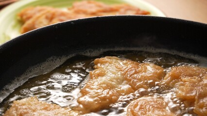 Crispy Fish Fillets Frying in Bubbling Oil. Shallow dof.