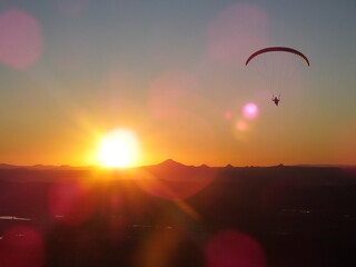Hang-gliders in the sky, flying at sunset, Mount Tambourine, Queensland.