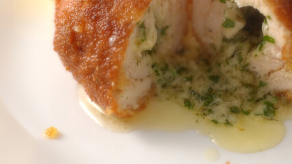 Halved Kiev Cutlet with cheese filling. Close-up, shallow dof.