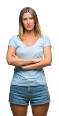 Young beautiful woman over isolated background skeptic and nervous, disapproving expression on face...