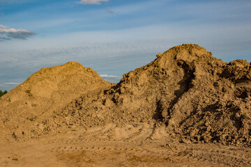 A mound of soil from overburden rocks in the quarry area