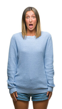 Young beautiful woman wearing winter sweater over isolated background afraid and shocked with surprise expression, fear and excited face.