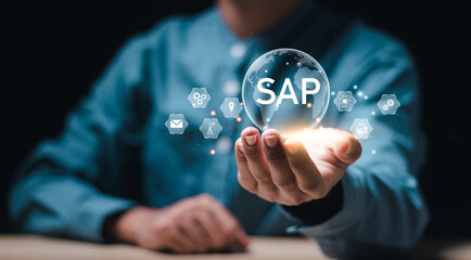 SAP or ERP enterprise resources planning system concept - Person hold virtual globe with SAP word for business process automation software and management software (SAP)