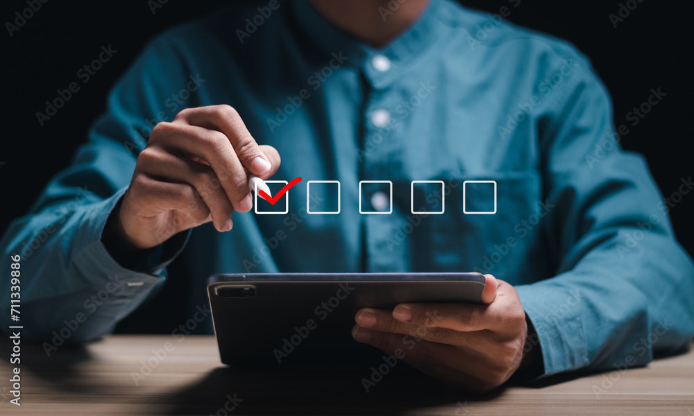 Poster businessman using tablet, checking mark on checkboxes. checklist concept.