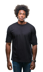 Afro american man over isolated background with serious expression on face. Simple and natural...