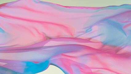 Pastel color transparent silk fabric flowing by wind, close-up