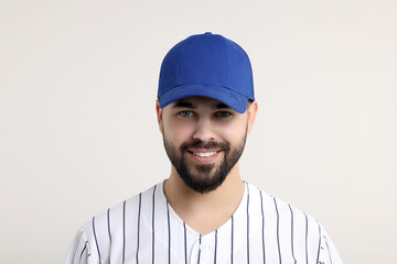 Man in stylish blue baseball cap on white background
