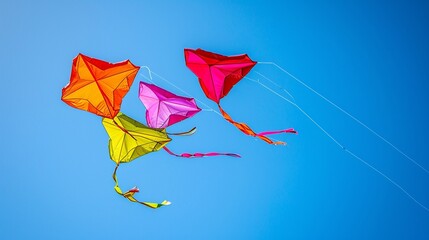 A series of colorful kites soaring high in the clear, blue sky
