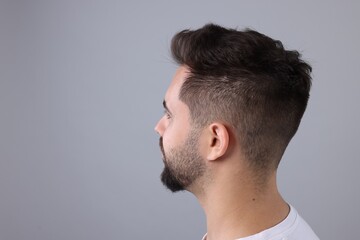 Fototapeta premium Man with healthy hair on light grey background, space for text