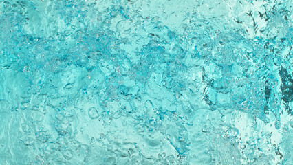 Fototapeta na wymiar Close-up of splashing water surface on light blue background