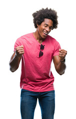 Afro american man over isolated background very happy and excited doing winner gesture with arms raised, smiling and screaming for success. Celebration concept.