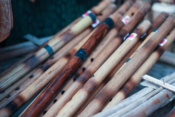 Assortment of beautifully crafted wooden flute sticks, neatly stacked together
