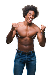 Fototapeta premium Afro american shirtless man showing nude body over isolated background very happy and excited doing winner gesture with arms raised, smiling and screaming for success. Celebration concept.