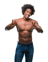 Fototapeta premium Afro american shirtless man showing nude body over isolated background smiling looking to the camera showing fingers doing victory sign. Number two.