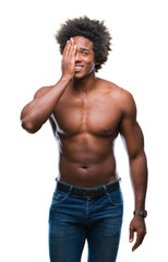 Fototapeta premium Afro american shirtless man showing nude body over isolated background covering one eye with hand with confident smile on face and surprise emotion.