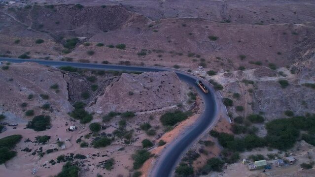 Aerial view of Mukran National Highway as a loaded truck is going down the road, Balochistan, Pakistan