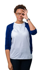 Young beautiful african american woman wearing glasses over isolated background doing ok gesture with hand smiling, eye looking through fingers with happy face.