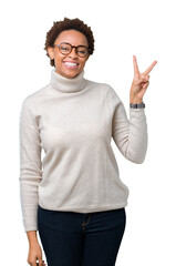 Fototapeta premium Young beautiful african american woman wearing glasses over isolated background smiling with happy face winking at the camera doing victory sign. Number two.