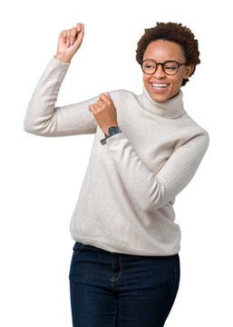 Young beautiful african american woman wearing glasses over isolated background Dancing happy and cheerful, smiling moving casual and confident listening to music