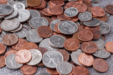 American coins and US dollars on a wooden table