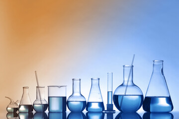 Laboratory glassware with liquid on table. Color toned