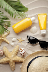 summer holiday accessories on the sandy beach. suntan lotion