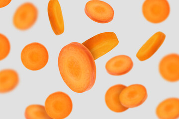 Fresh carrot slices falling on light grey background