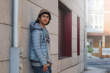 urban young man posing on street wall