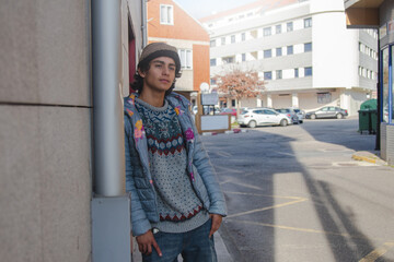 urban young man posing on street wall