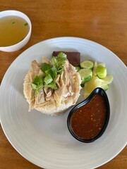 Hainanese chicken rice with soup and dipping sauce .Street food in Thailand