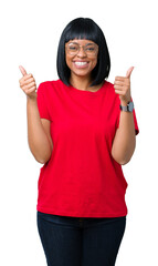 Beautiful young african american woman wearing glasses over isolated background success sign doing positive gesture with hand, thumbs up smiling and happy. Looking at the camera.