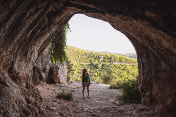 woman tourist exploring a cave