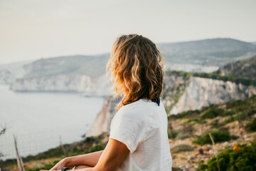 woman tourist relaxing and watching rocks in the sea