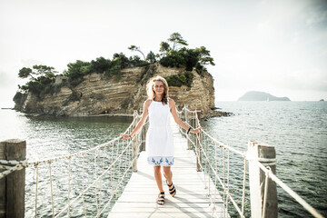 wooden footbridge leading to the small island of Agios Sostis on Zakynthos, Greece, during a sunny...