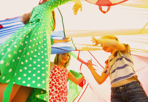 Children Playing under Parachute
