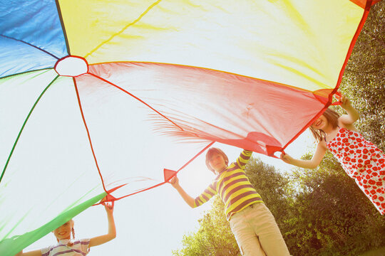Children Playing under Parachute
