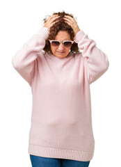 Beautiful middle ager senior woman wearing pink sweater and sunglasses over isolated background suffering from headache desperate and stressed because pain and migraine. Hands on head.