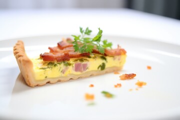 whole quiche lorraine on a white plate, garnished with parsley