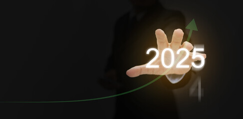 Happy new year 2025. A man reaches out his hand to take new opportunities in 2025 with a rising...