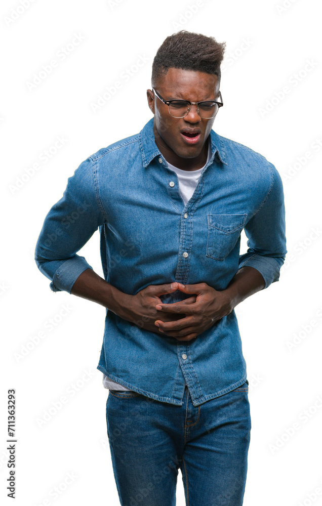 Poster Young african american man over isolated background with hand on stomach because indigestion, painful illness feeling unwell. Ache concept.