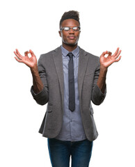 Young african american business man over isolated background relax and smiling with eyes closed doing meditation gesture with fingers. Yoga concept.
