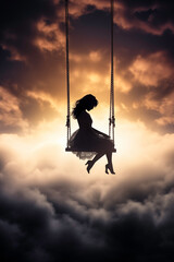 Silhouette of a Woman on a Swing in the Sky During a Dramatic Sunset