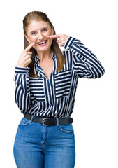 Middle age mature business woman over isolated background smiling confident showing and pointing with fingers teeth and mouth. Health concept.